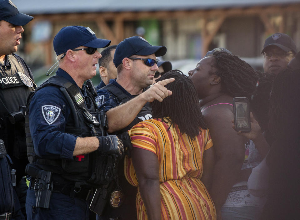 FILE - Brittany Martin, center, wearing striped clothing, confronts police as demonstrators in support of George Floyd march with an escort around downtown Sumter, S.C., on May 31, 2020. Martin, a pregnant Black activist serving four years in prison over comments she made to police during racial justice protests in the summer of 2020, will not receive a lesser sentence, a judge has ruled. (Micah Green/The Item via AP, File)