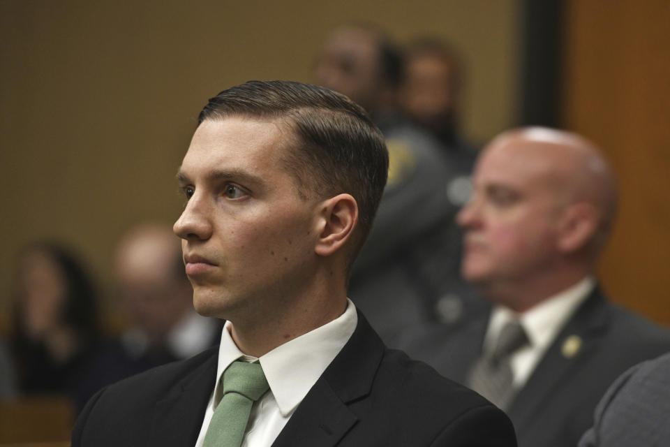 State Trooper Brian North, center, listens as a jury reads a verdict of not guilty on all counts in Connecticut Superior Court in Milford, Conn., Friday, March 15, 2024. North was acquitted of all charges Friday in the death of Mubarak Soulemane, a community college student with mental illness who was shot as he sat behind the wheel of a stolen car holding a kitchen knife. (Ned Gerard/Hearst Connecticut Media via AP, Pool)