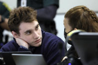 Marjory Stoneman Douglas High School shooter Nikolas Cruz speaks with paralegal Melissa Sly during a break in the penalty phase of Cruz's trial at the Broward County Courthouse in Fort Lauderdale, Fla., Thursday, Sept. 1, 2022. Cruz previously plead guilty to all 17 counts of premeditated murder and 17 counts of attempted murder in the 2018 shootings. (Amy Beth Bennett/South Florida Sun Sentinel via AP, Pool)