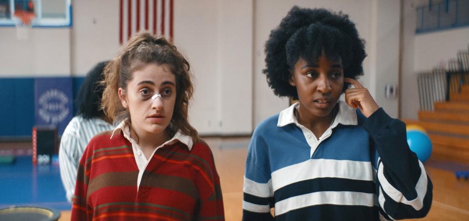 Rachel Sennott and Ayo Edebiri in a scene from the movie "Bottoms," both wearing casual striped tops