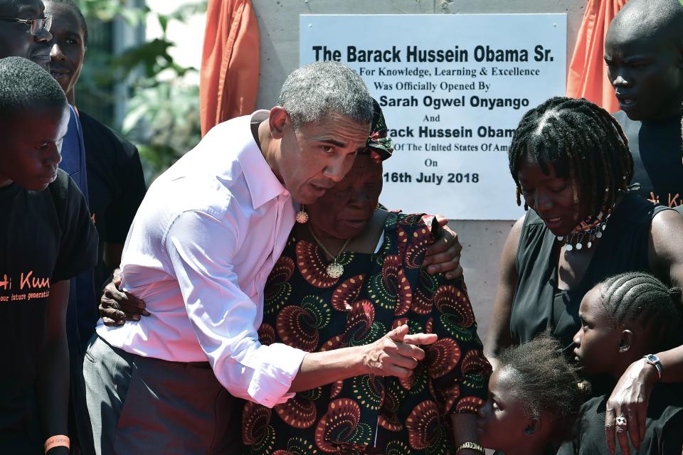 <p>Former US President, Barak Obama (3rdL) with his step-grandmother Sarah (C) and half-sister, Auma (2ndR) and some of the local youth are pictured on July 16, 2018 following the unveiling of a plaque during the opening of the Sauti Kuu Resource Centre, founded by his half-sister, Auma Obama at Kogelo in Siaya county, western Kenya. – Obama is in the East African nation for the first time since he left the US presidency and met with President Uhuru Kenyatta and opposition leader Raila Odinga in Nairobi. (Photo: Tony Karumba/AFP/Getty Images) </p>