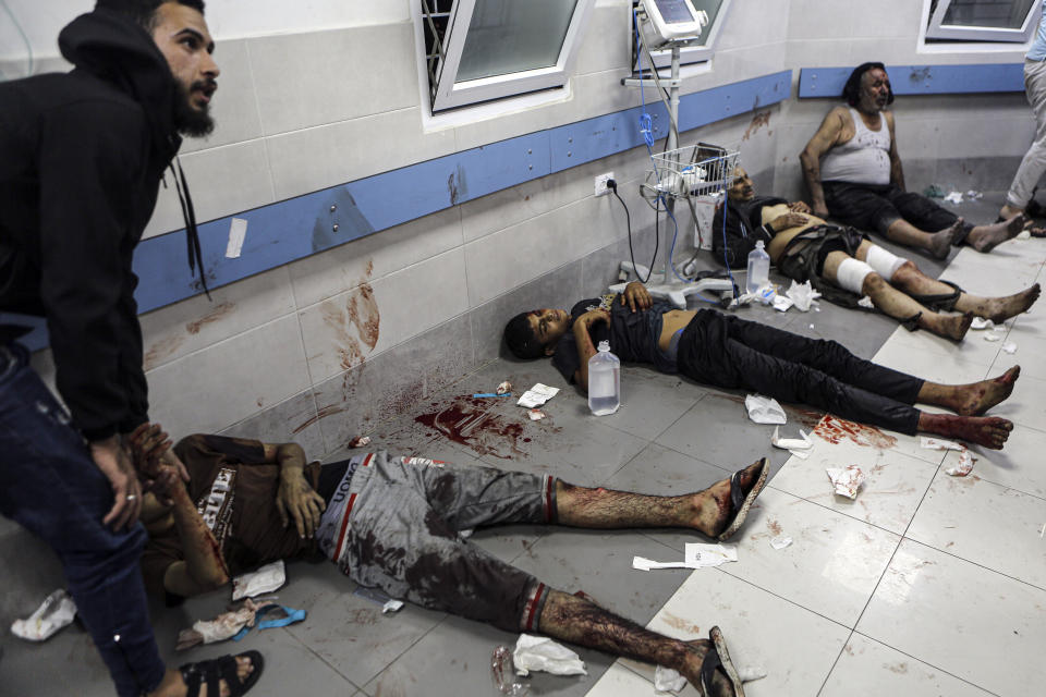 Wounded Palestinians lie on the floor in al-Shifa Hospital in Gaza City, central Gaza Strip, after arriving from al-Ahli Hospital following an explosion there, Tuesday, Oct. 17, 2023. The Hamas-run Health Ministry says an Israeli airstrike caused the explosion that killed hundreds at al-Ahli, but the Israeli military says it was a misfired Palestinian rocket. (AP Photo/Abed Khaled)