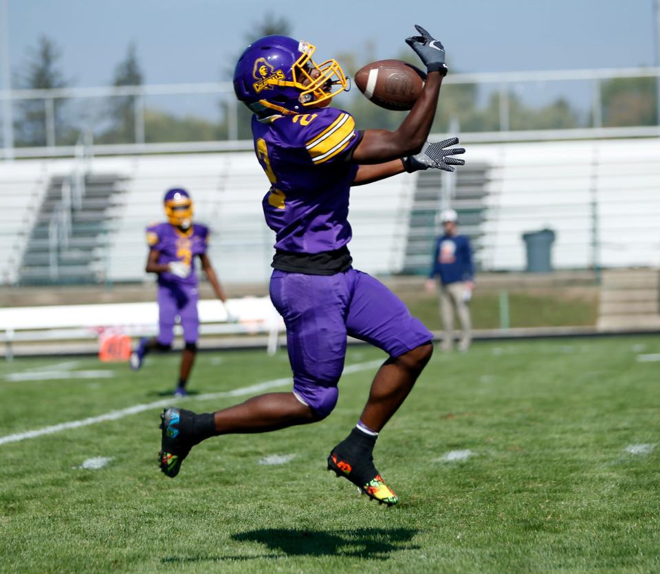 South Bend Clay senior Jeremiah Cherry catches a pass, eventually running it in for the game's first touchdown against North Newton Saturday, Sept. 30, 2023, at Clay Middle School in South Bend.