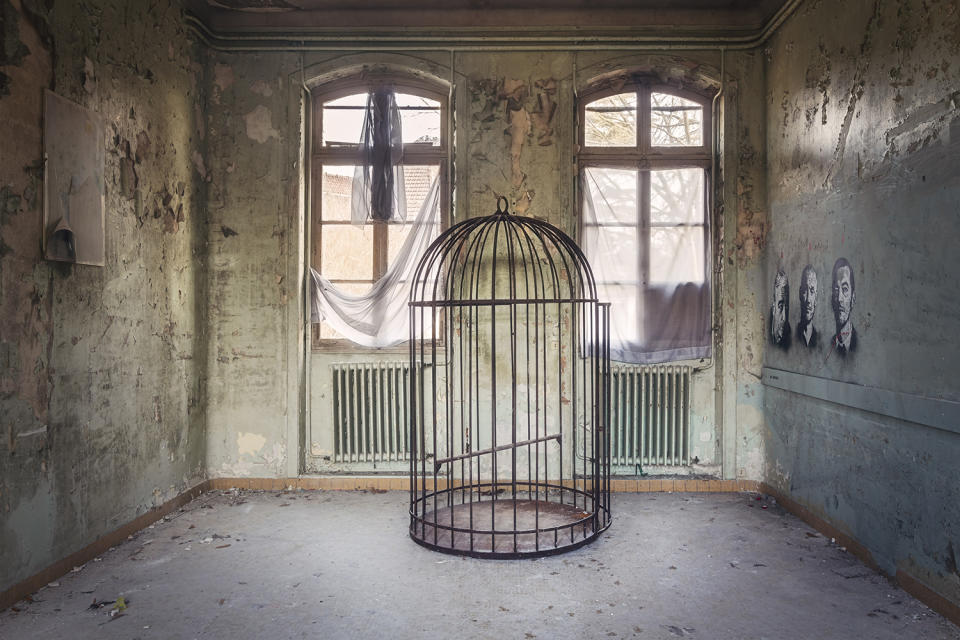 Abandoned room with bird cage in France