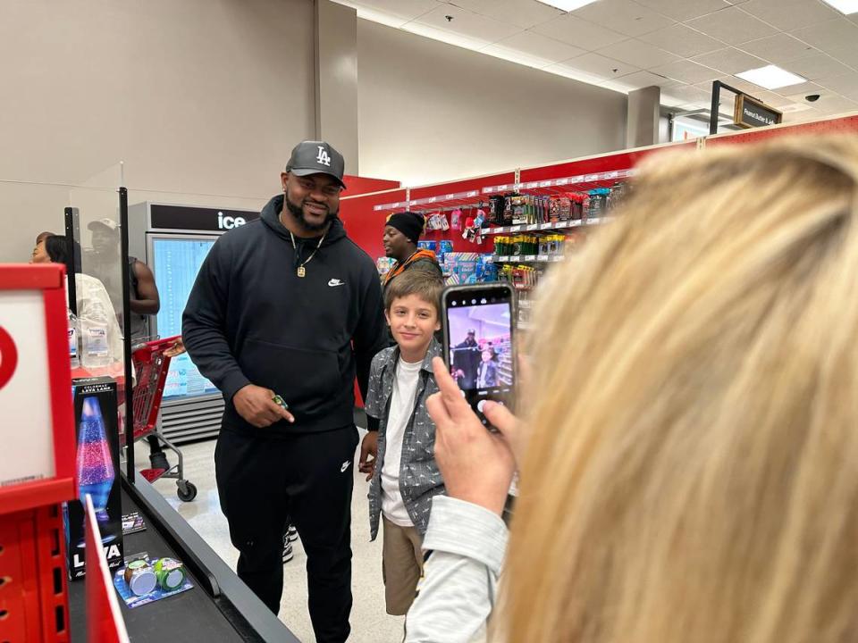 Demarcus Christmas and Nathan Wood, 12, pose for a picture taken by Wood’s mom before checking out at Target on Sunday. Wood was excited to buy a lava lamp to decorate his room with for Christmas. 12/17/2022