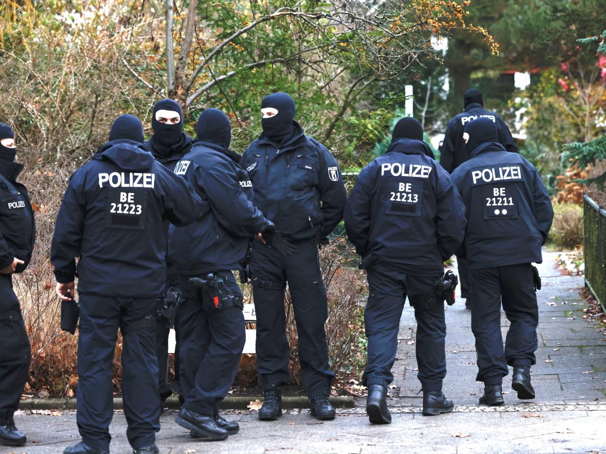 olice stand outside a residence that they raided earlier today on December 7, 2022 in Berlin, Germany