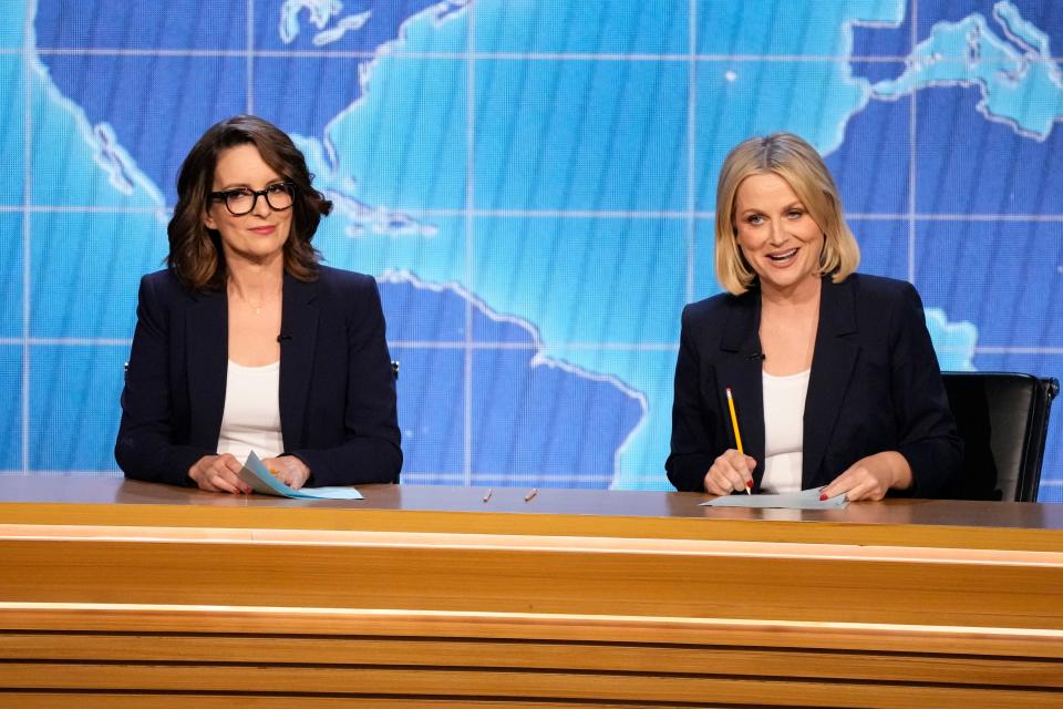 Tina Fey (left) and Amy Poehler were back at the "Weekend Update" desk to present the award for outstanding live variety special during the 75th Emmy Awards.