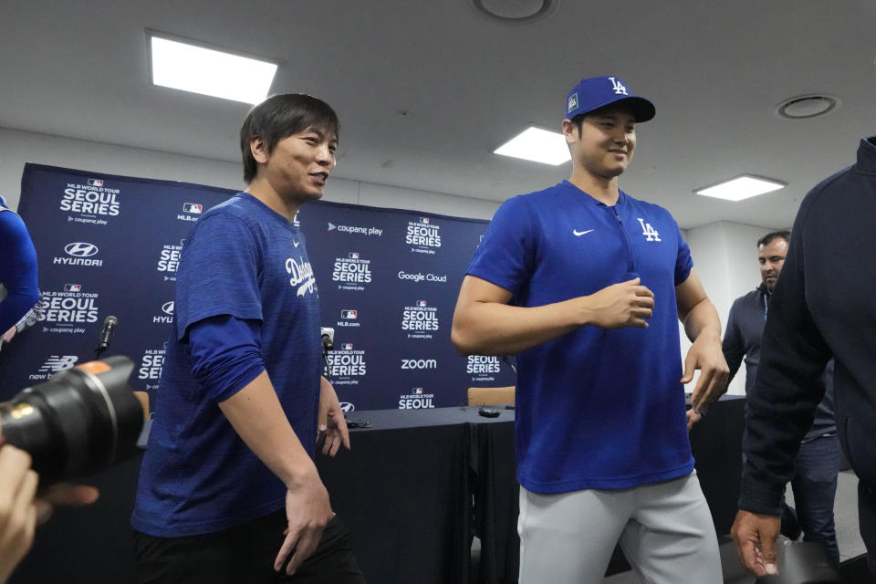 Los Angeles Dodgers' Shohei Ohtani, right, and his interpreter, Ippei Mizuhara, leave after a news conference ahead of a baseball workout at Gocheok Sky Dome in Seoul, South Korea, Saturday, March 16, 2024. Ohtani’s interpreter and close friend has been fired by the Dodgers following allegations of illegal gambling and theft from the Japanese baseball star. (AP Photo/Lee Jin-man)