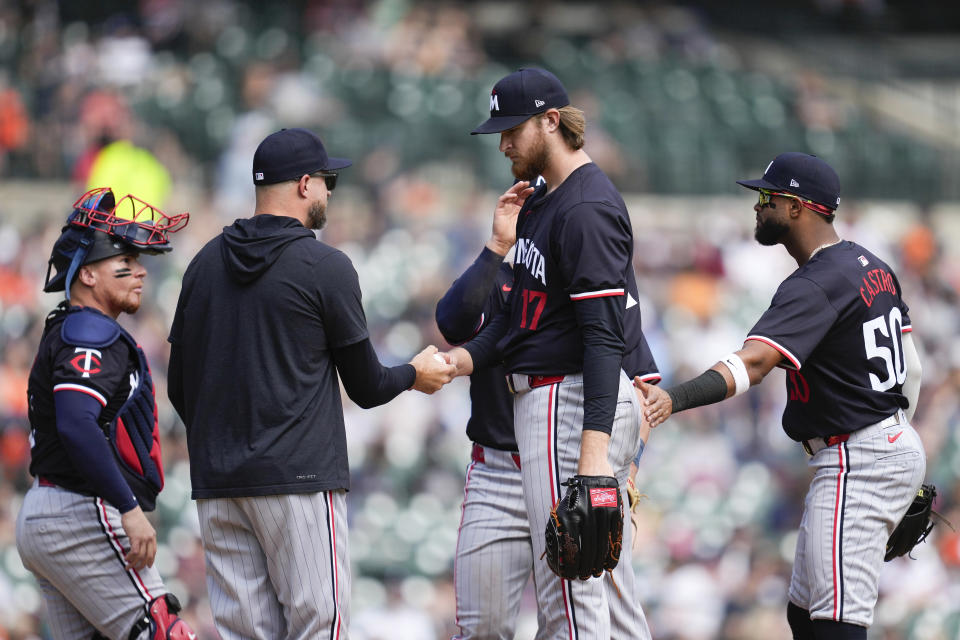 Minnesota Twins manager Rocco Baldelli takes the ball from pitcher Bailey Ober (17) in the seventh inning of a baseball game against the Detroit Tigers, Sunday, April 14, 2024, in Detroit. (AP Photo/Paul Sancya)