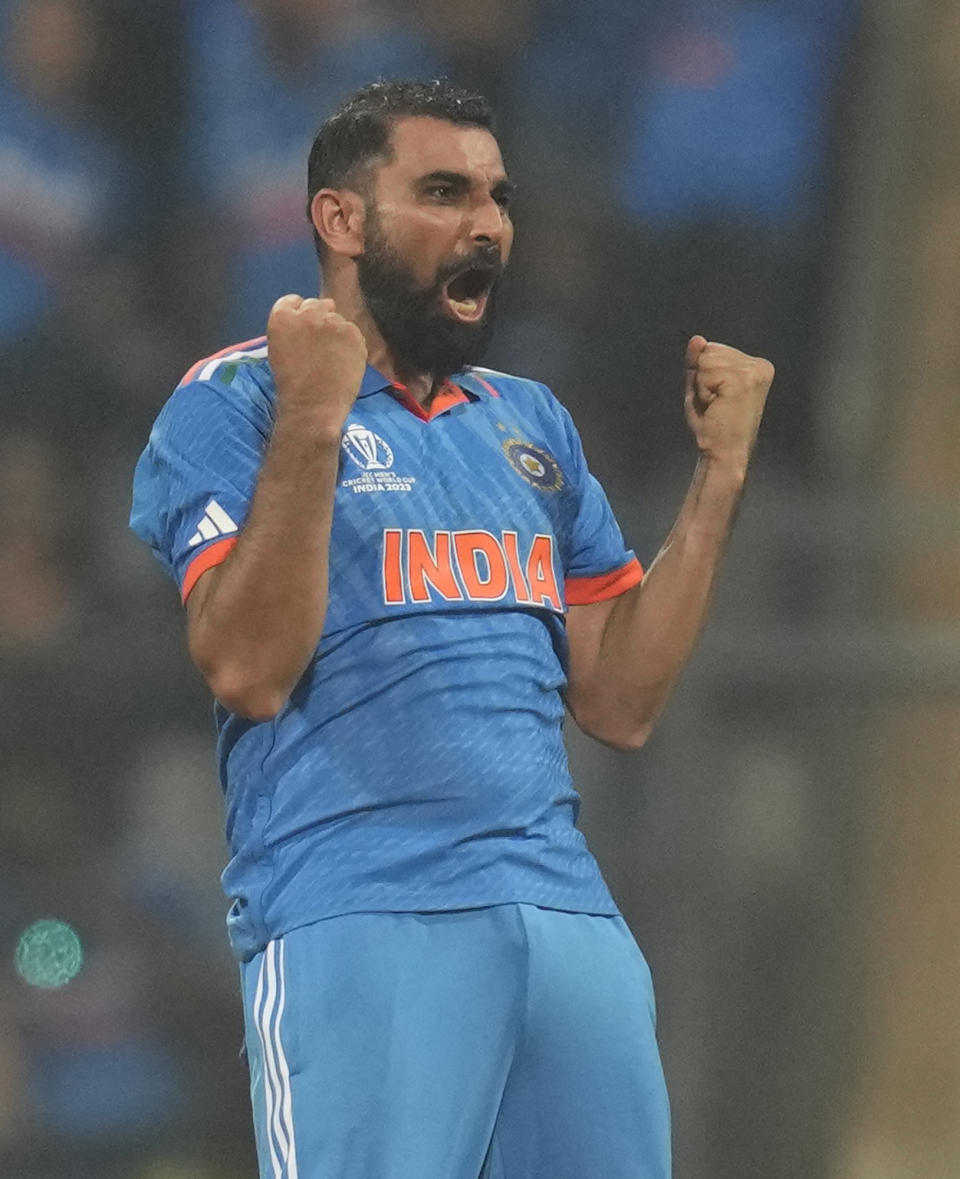 India's Mohammed Shami celebrates the wicket of New Zealand's Daryl Mitchell and also five wicket haul during the ICC Men's Cricket World Cup first semifinal match between India and New Zealand in Mumbai, India, Wednesday, Nov. 15, 2023. (AP Photo/Rafiq Maqbool)