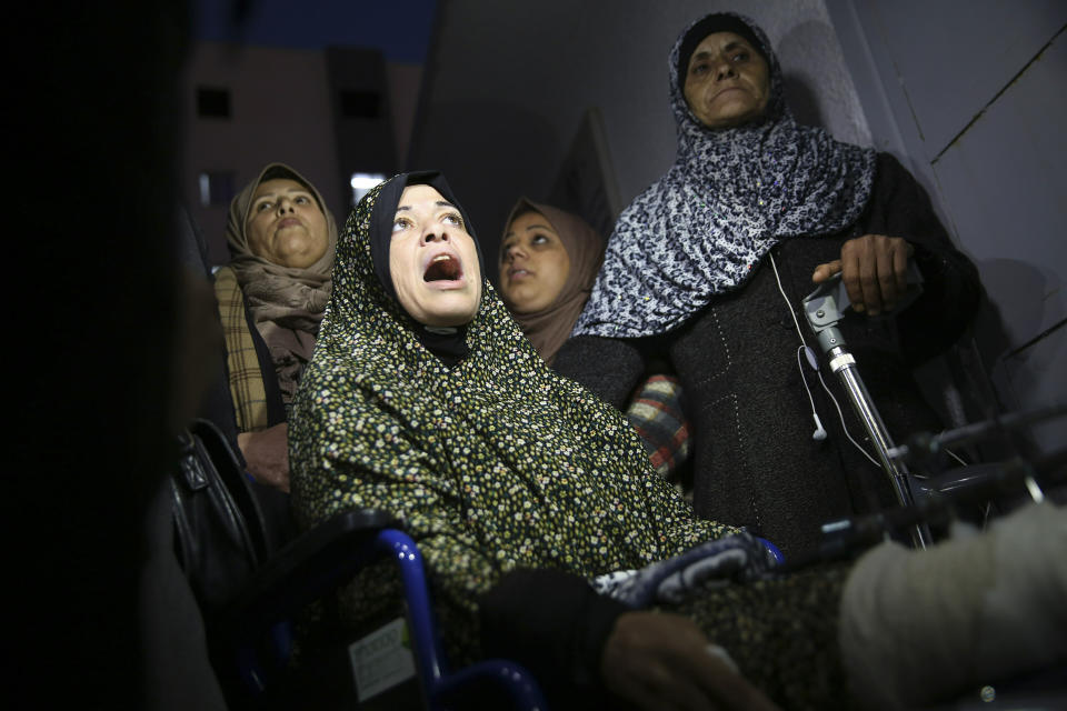 Relatives react in front of the morgue of Shifa hospital while wait to see the body of a woman who was shot and killed by Israeli troops during a protest at the Gaza Strip's border with Israel, in Gaza City, Friday, Jan. 11, 2019. Spokesman Ashraf al-Kidra says the woman was shot in the head Friday at a protest site east of Gaza City. (AP Photo/Adel Hana)