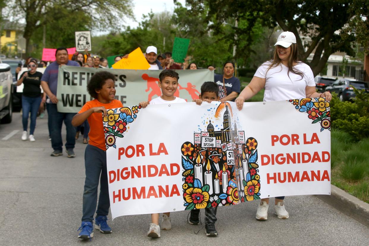 Members of Escucha Mi Voz march along Iowa Avenue while protesting a new state immigration law Wednesday, May 1, 2024 in Iowa City, Iowa.