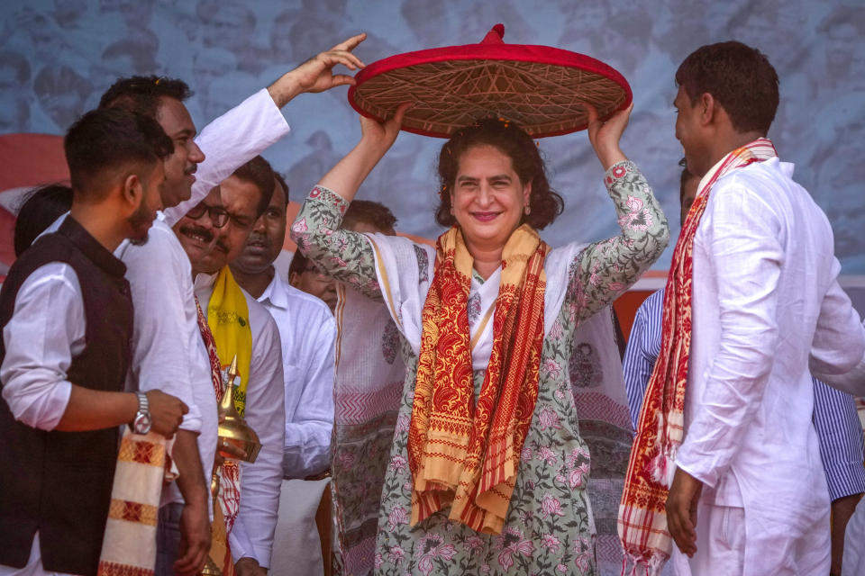 Congress party leader Priyanka Gandhi receives an Assamese Japi during an election rally in Dhubri district in lower Assam, India, Wednesday, May 1, 2024. (AP Photo/Anupam Nath)