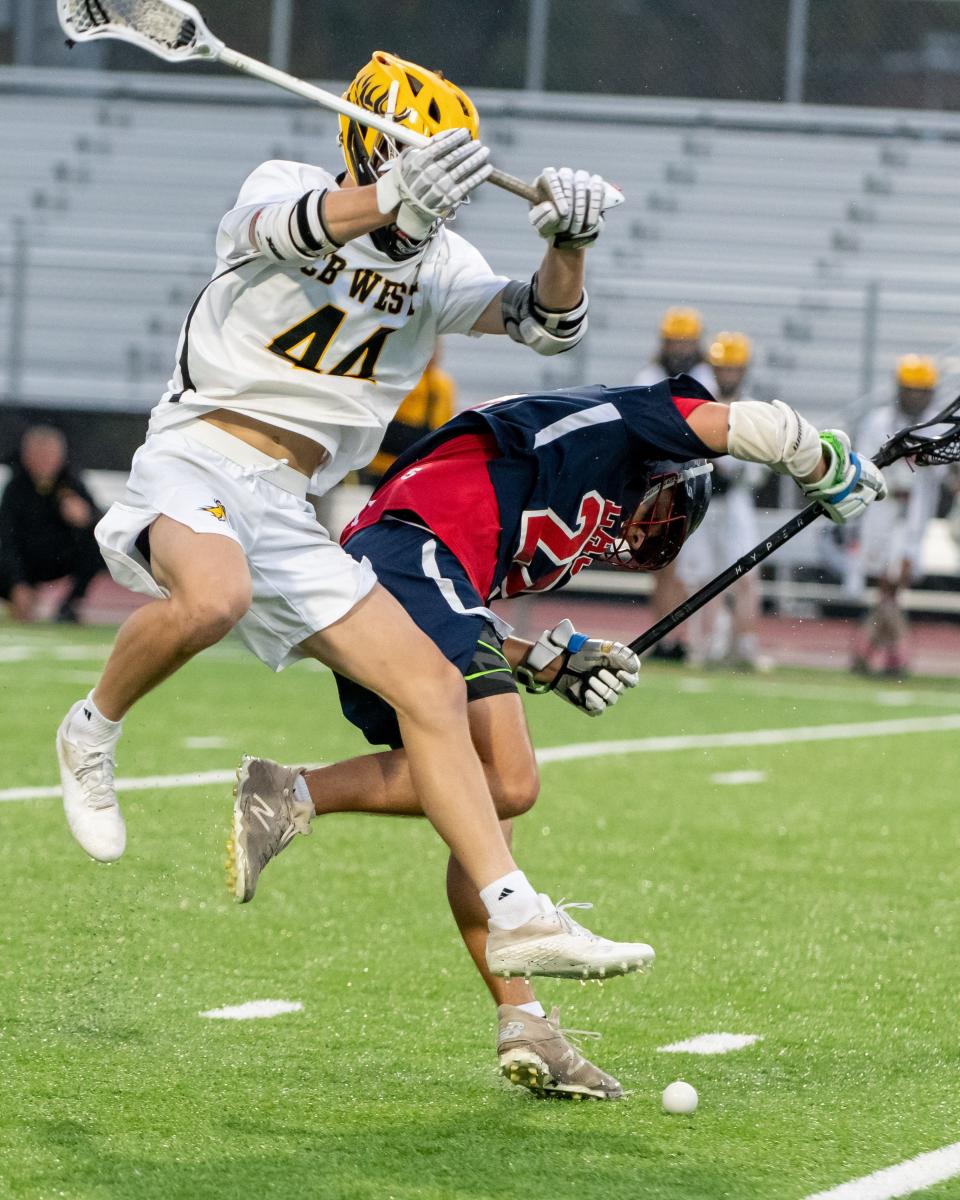 Central Bucks West's Austin Hahn (left) and Central Bucks East's Luke Christmas battle for a loose ball.