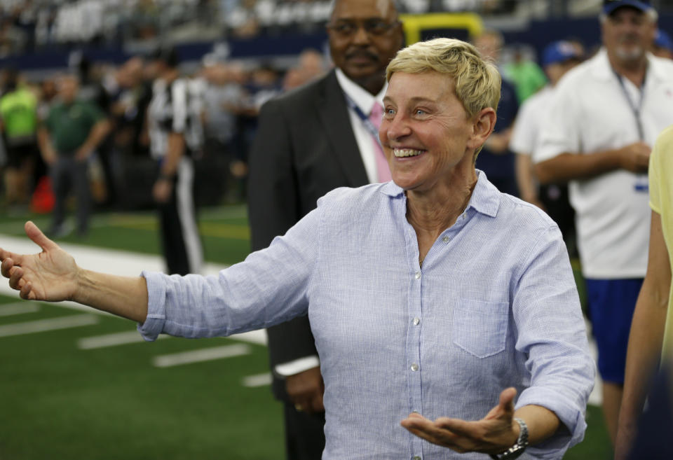 FILE - In this Oct. 6, 2019, file photo, entertainer Ellen DeGeneres walks on the field during warmups before an NFL football game between the Green Bay Packers and the Dallas Cowboys in Arlington, Texas. DeGeneres is among those offering a prize in the All In Challenge, which was started by Philadelphia 76ers minority owner Michael Rubin on Tuesday, April 14, 2020. (AP Photo/Ron Jenkins, File)