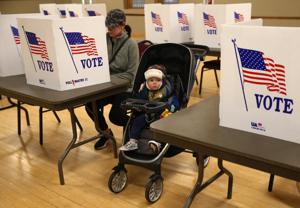 A Missouri mother casts her vote in the state's presidential primary on March 10 in St. Charles, Missouri. The exemptions that allow absentee voting in the state are limited. (Photo: Laurie Skrivan/St. Louis Post-Dispatch via Getty Images)