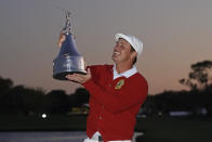 Bryson DeChambeau holds up his championship trophy after winning the Arnold Palmer Invitational golf tournament Sunday, March 7, 2021, in Orlando, Fla. (AP Photo/John Raoux)