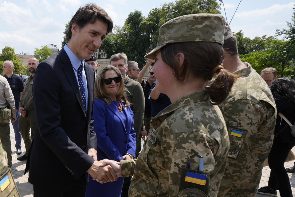 Canadian Prime Minister Justin Trudeau, left, accompanied by Deputy Prime Minister and Minister of Finance Chrystia Freeland, center, meets with soldiers in Kyiv, Ukraine, on Saturday, June 10, 2023. (Frank Gunn/The Canadian Press via AP)