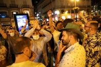 People celebrate as the state of emergency decreed by the Spanish Government to prevent the spread of the coronavirus disease (COVID-19) gets lifted in Madrid