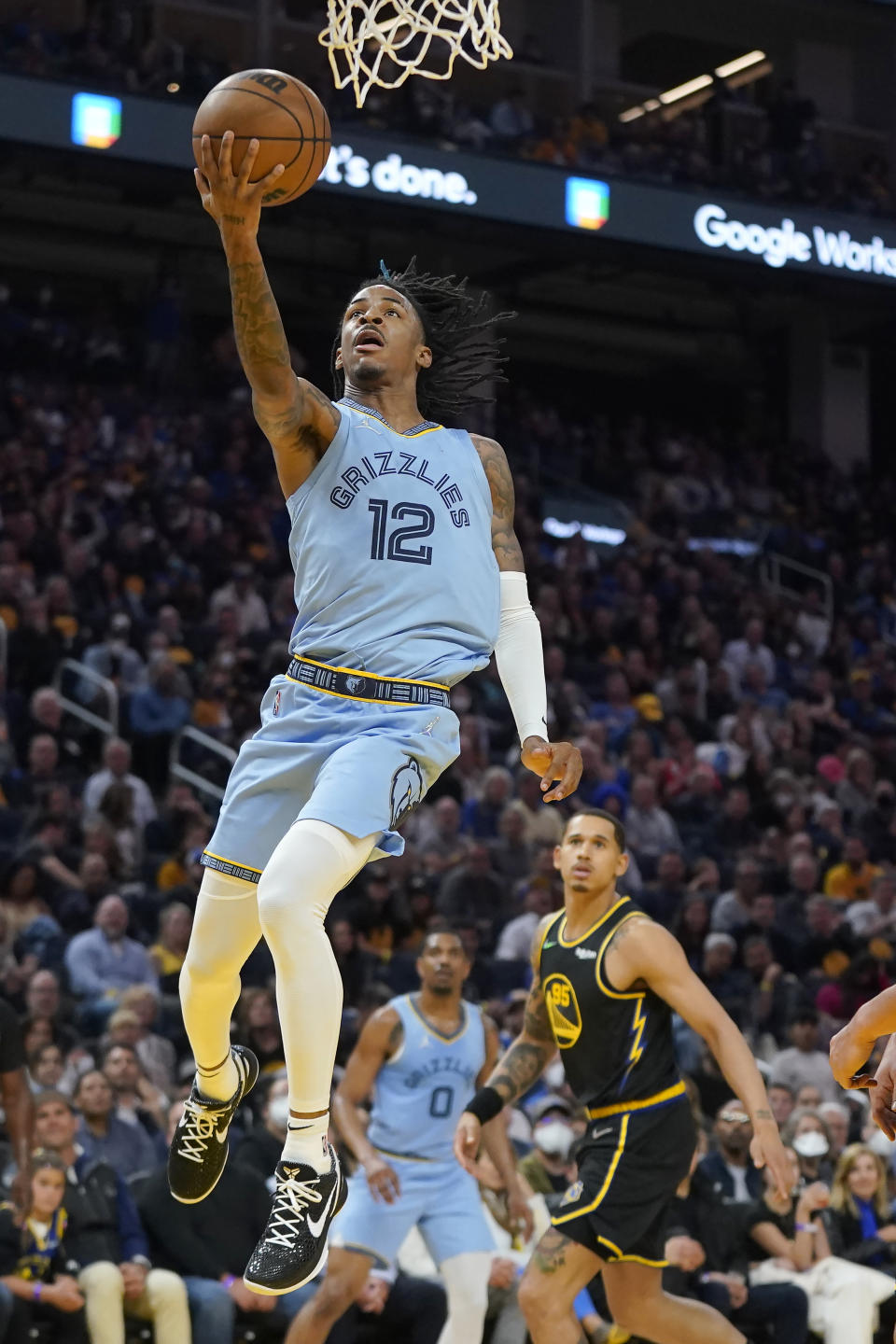 Memphis Grizzlies guard Ja Morant (12) scores against the Golden State Warriors during the second half of Game 3 of an NBA basketball Western Conference playoff semifinal in San Francisco, Saturday, May 7, 2022. (AP Photo/Jeff Chiu)
