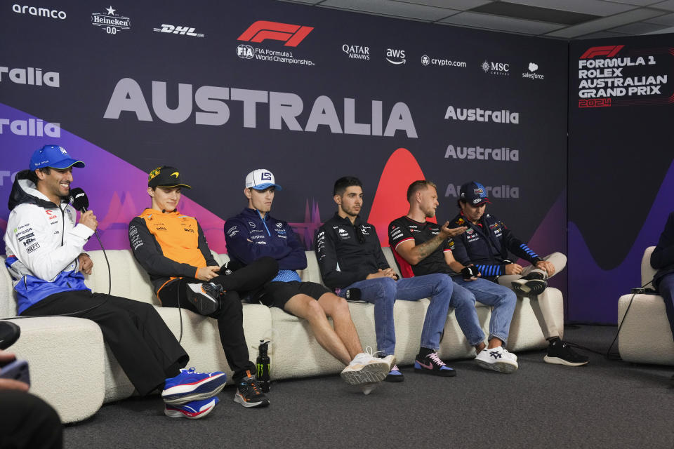 Formula one drivers from left, Daniel Ricciardo of Australia driver of RB, the team previously known as AlphaTauri, McLaren driver Oscar Piastri of Australia, Williams driver Logan Sargeant of the US, Alpine driver Esteban Ocon of France, Haas driver Kevin Magnussen of Denmark, and Red Bull driver Sergio Perez of Mexico react during the drivers press conference ahead of the Australian Formula One Grand Prix at Albert Park, Melbourne, Australia, Thursday, March 21, 2024. (AP Photo/Asanka Brendon Ratnayake)