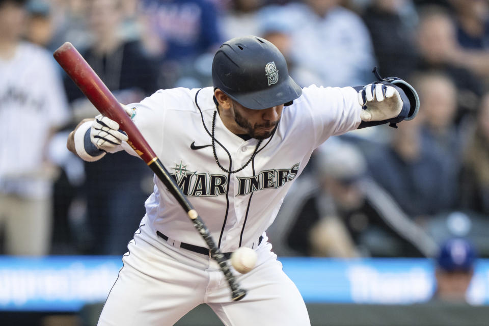 Seattle Mariners' Jose Caballero fouls off pitch from Texas Rangers' Andrew Heaney off the handle of his bat during the third inning of a baseball game Tuesday, May 9, 2023, in Seattle. (AP Photo/Stephen Brashear)