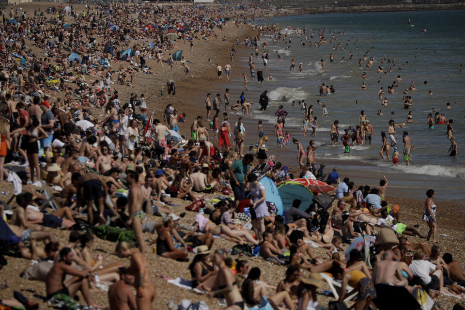 FILE - In this Wednesday, June 24, 2020 file photo on Britain's hottest day of the year so far with temperatures reaching 32.6 degrees Celsius (90 degrees Fahrenheit) at Heathrow airport, people relax on Brighton Beach in Brighton, England. (AP Photo/Matt Dunham, File)