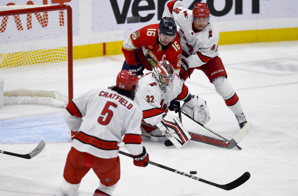 Carolina Hurricanes goaltender Antti Raanta (32) looks for the puck in front of Florida Panthers center Aleksander Barkov (16) during the first period of an NHL hockey game Friday, Nov. 10, 2023, in Sunrise, Fla. (AP Photo/Michael Laughlin)