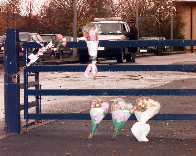 Flowers tied to the gates of a school in Exeter in memory of Kate Bushell