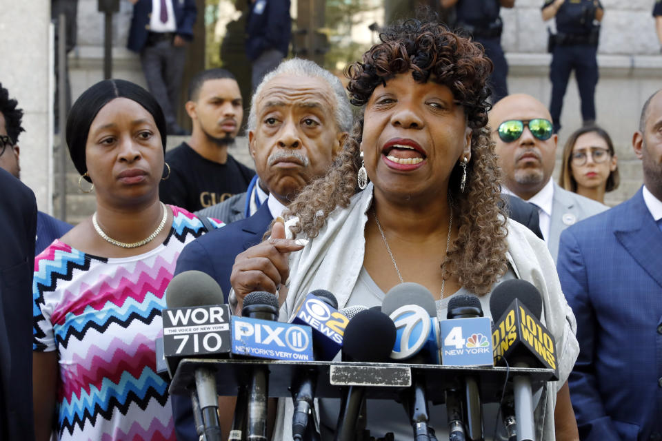 Gwen Carr, mother of chokehold victim Eric Garner, speaks outside the U.S. Attorney's office, in the Brooklyn borough of New York, Tuesday, July 16, 2019, as Rev. Al Sharpton listens, center. Federal prosecutors won't bring civil rights charges against New York City police officer Daniel Pantaleo, in the 2014 chokehold death of Garner, a decision made by Attorney General William Barr and announced one day before the five-year anniversary of his death, officials said. (AP Photo/Richard Drew)