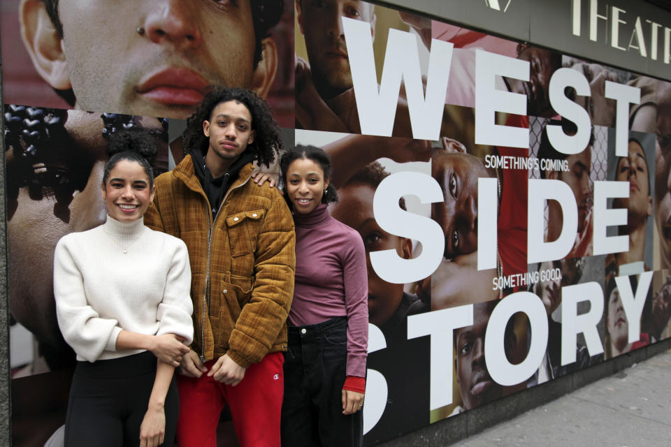 In this Tuesday, Feb. 18, 2020 photo, from left, Ilda Mason, Israel Del Rosario and Satori Folkes-Stone pose outside the Broadway Theatre in New York, where they are making their Broadway debuts in "West Side Story." The revival opens Thursday night and boasts 33 young people making their Broadway debuts. (Lisa Tolin via AP)