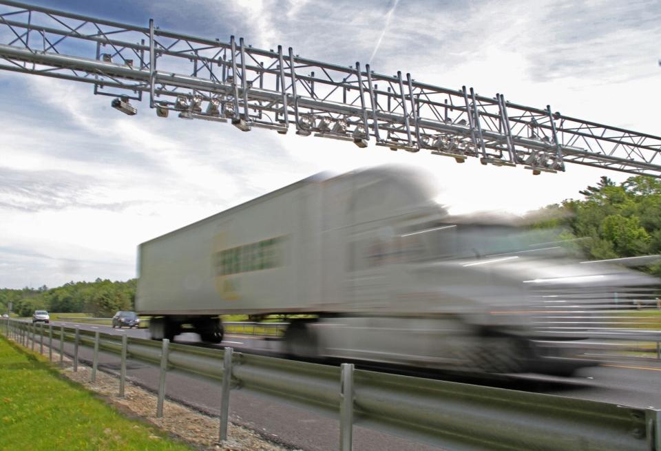 A truck passes under a toll gantry on Interstate 95 in South County.