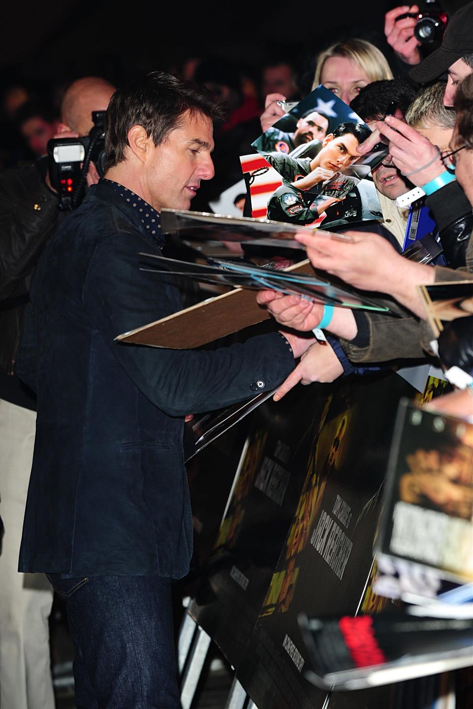 Tom Cruise signing autographs for fans at the World Premier of 'Jack Reacher'.