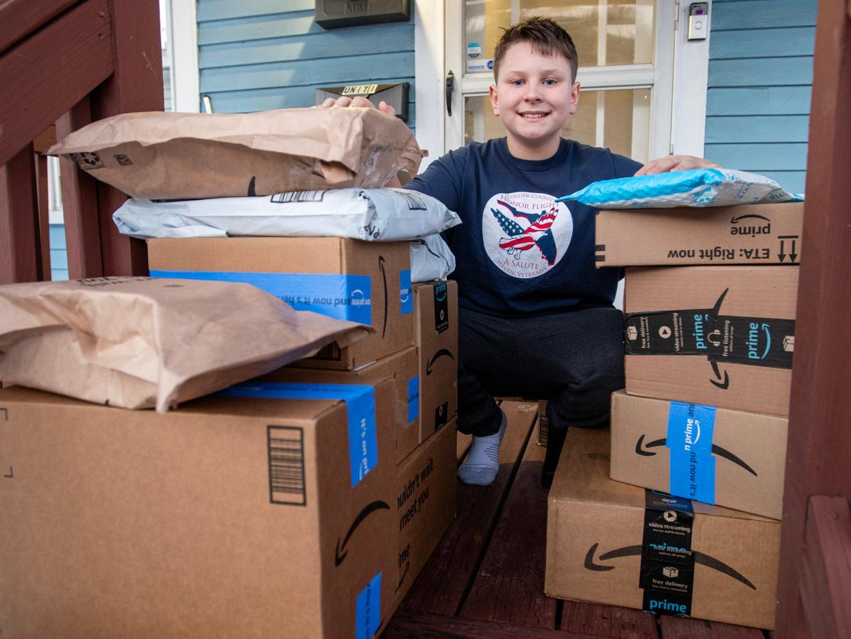 Joshua Sowden, 12, with some of the boxes of items that will go into Easter baskets Wednesday.