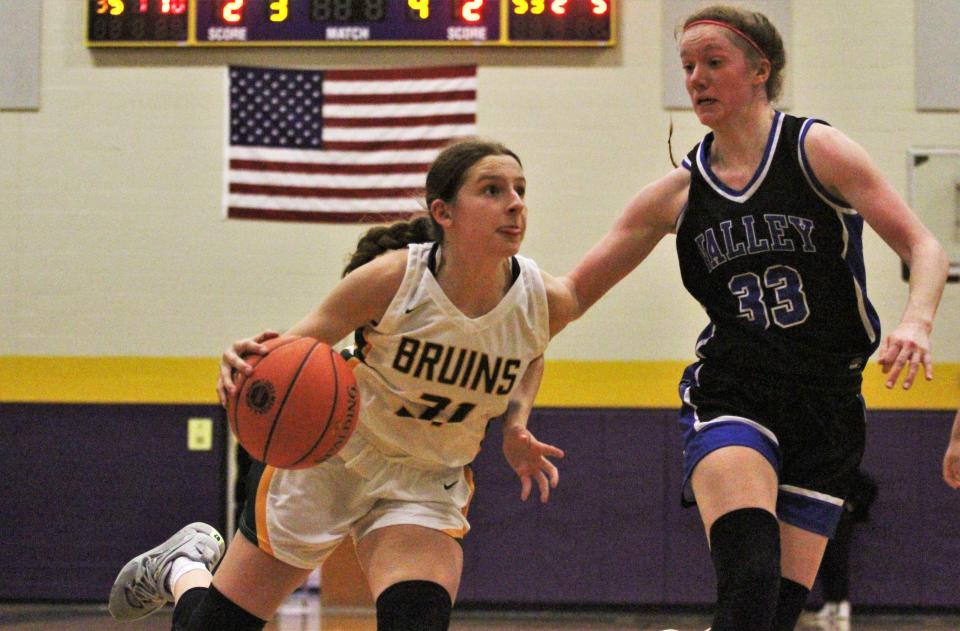 Rock Bridge's Mari Miller (31) drives on Grain Valley's Grace Slaughter (33) during the Class 6 District 7 championship game on March 7, 2023, at Hickman High School.