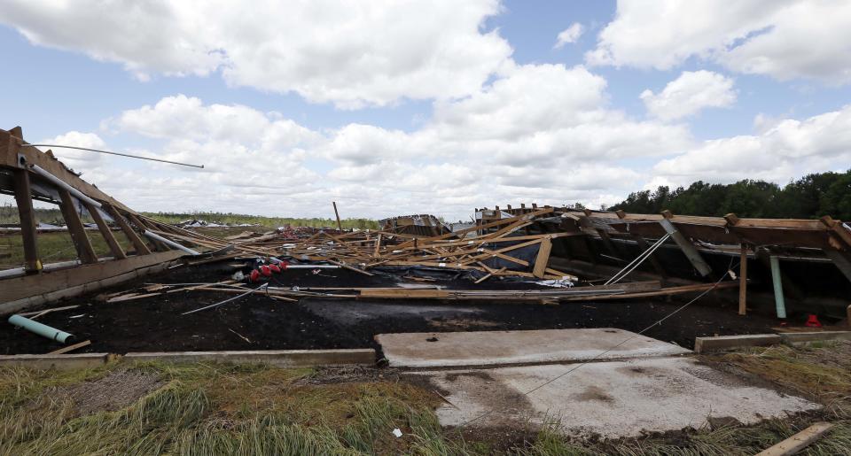 2Just lumber remains at the site of one of the chicken houses at the Hartness Farms, a 12-chicken house operation that was leveled in Noxapater, Miss., Wednesday, April 30, 2014. The farm was sold on Friday and its new owners were at the farm when a tornado demolished the property and injured them. There were no chickens at the farm. (AP Photo/Rogelio V. Solis)