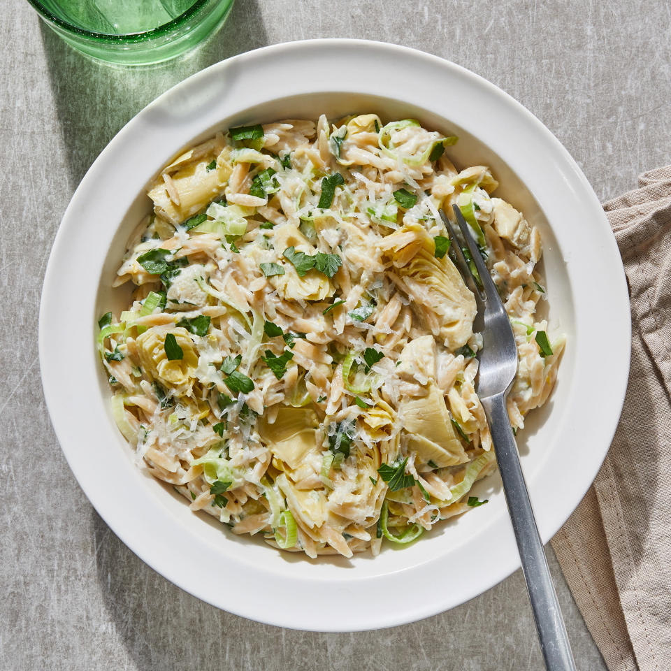 <p>This creamy artichoke pasta uses lemon zest and parsley to balance the richness of the Parmesan cheese sauce. You can use frozen or canned artichoke hearts in this healthy pasta recipe. <a href="https://www.eatingwell.com/recipe/7918913/creamy-artichoke-pasta/" rel="nofollow noopener" target="_blank" data-ylk="slk:View Recipe" class="link ">View Recipe</a></p>