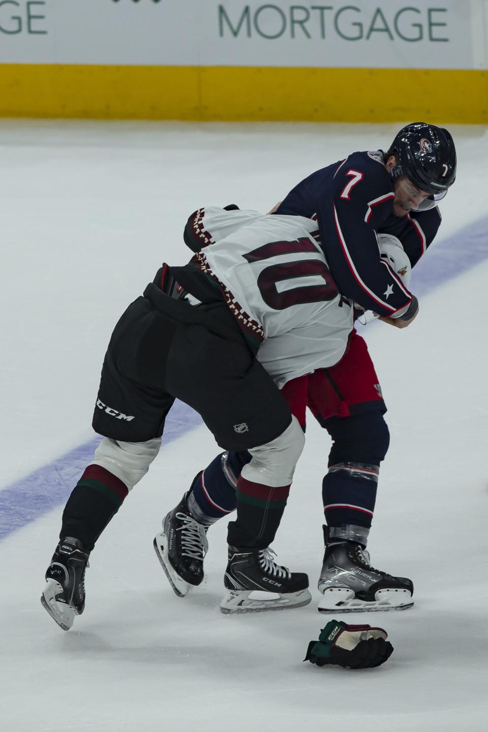 Columbus Blue Jackets center Sean Kuraly (7) and Arizona Coyotes left wing Ryan Dzingel (10) fight during the second period of the NHL game at Nationwide Arena in Columbus, Ohio Oct. 14.