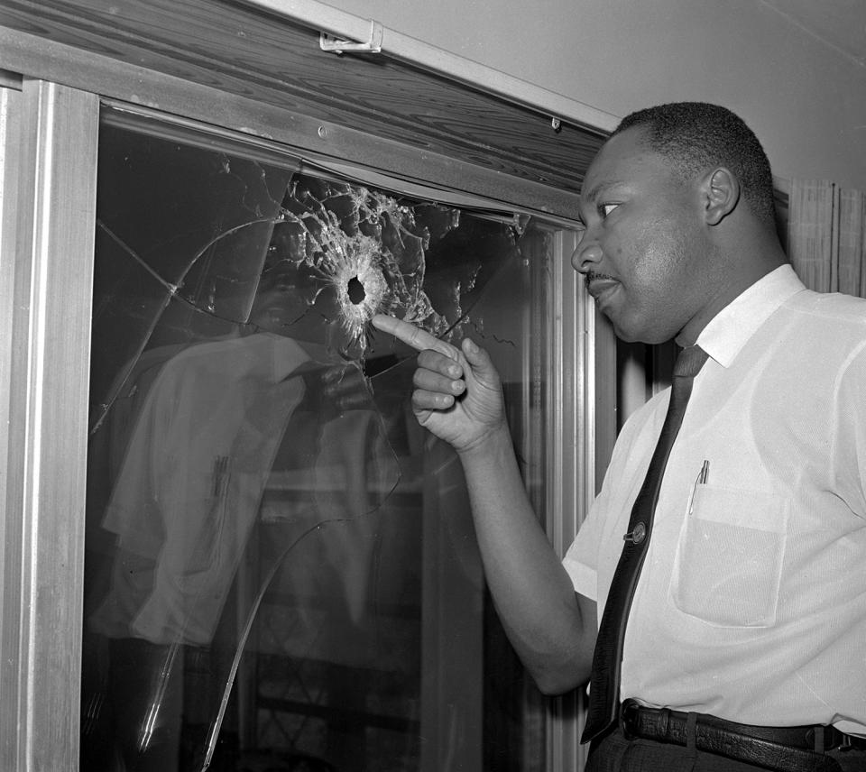 <p>Integration leader Dr. Martin Luther King looks at a glass door of his rented beach cottage in St. Augustine, Fla. that was shot into by someone unknown on June 5, 1964. King took time out from conferring with St. Augustine integration leaders to inspect the house, which no one was in at the time of the shooting. (AP Photo/Jim Kerlin) </p>