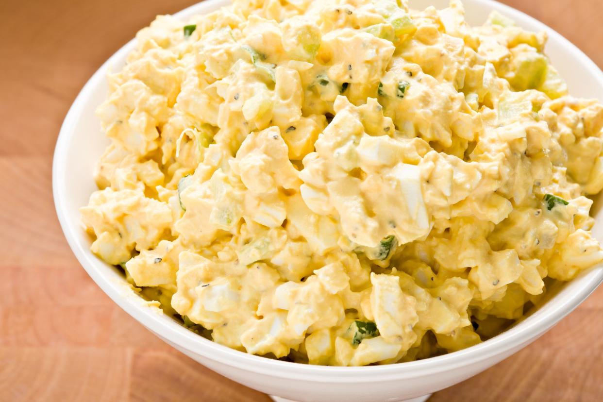 A high angle close up of freshly made egg salad in a bowl.