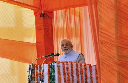 Prime Minister Narendra Modi addresses during a gathering after inaugurating a train on a new stretch of railway to the town of Katra, northwest of Jammu July 4, 2014. REUTERS/Mukesh Gupta