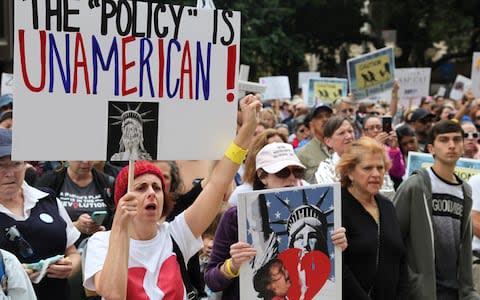 People take part in the "Families Belong Together" protest in San Diego - Credit: Xinhua / Barcroft Images