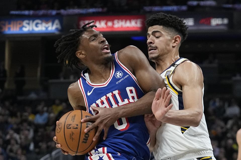 Philadelphia 76ers' Tyrese Maxey (0) goes to the basket against Indiana Pacers' Ben Sheppard during the first half of an NBA basketball game Thursday, Jan. 25, 2024, in Indianapolis. (AP Photo/Darron Cummings)