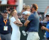 Jun 19, 2016; Oakmont, PA, USA; Dustin Johnson celebrates with fiance Paulina Gretzky while holding their son Tatum after winning the U.S. Open golf tournament at Oakmont Country Club. Mandatory Credit: Charles LeClaire-USA TODAY Sports