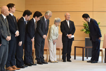 Japan's Prime Minister Shinzo Abe (R) meets family members of victims abducted to North Korea at the Prime Minister's official residence in Tokyo, Japan, June 14, 2018. Kazuhiro Nogi/Pool via Reuters