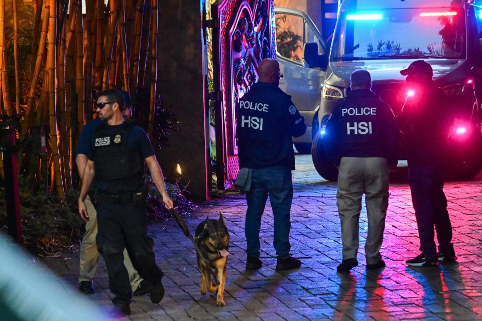 Homeland Security Investigation agents are seen at the entrance of Combs' home at Star Island in Miami Beach on March 25, 2024.