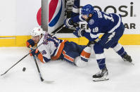 Tampa Bay Lightning's Barclay Goodrow (19) checks New York Islanders' Anthony Beauvillier (18) during the first period of an NHL Eastern Conference final playoff game, Monday, Sept. 7, 2020, in Edmonton, Alberta. (Jason Franson/The Canadian Press via AP)