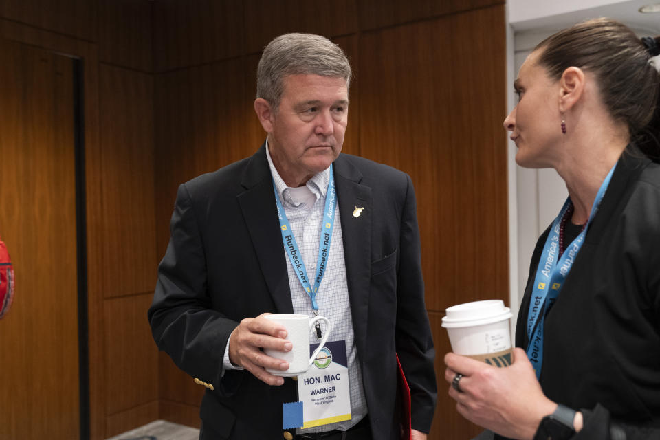 Mac Warner, Secretary of State for West Virginia, left, speaks with Cait Conley, of the Cybersecurity and Infrastructure Security Agency (CISA), during the summer meeting of the National Association of Secretaries of State, Tuesday, July 11, 2023, in Washington. Efforts to deceive the public about voting and elections remain a top concern for state election officials as they dig into preparations for the 2024 election. (AP Photo/Jacquelyn Martin)