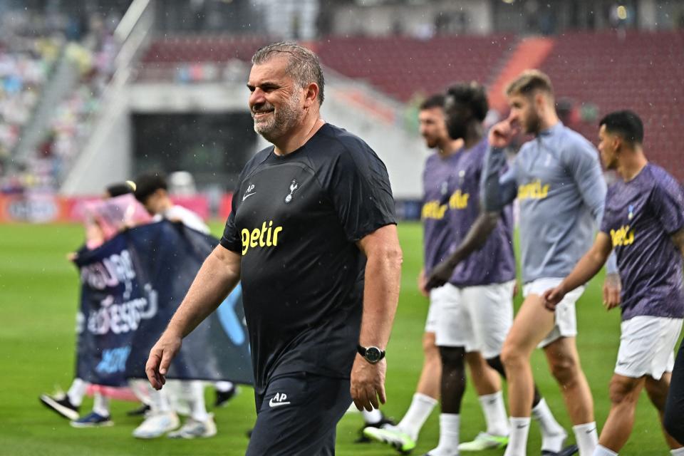 Tottenham manager Ange Postecoglou joins his players on a lap of the pitch to thank supporters after Spurs’ pre-season friendly is cancelled (AFP via Getty Images)