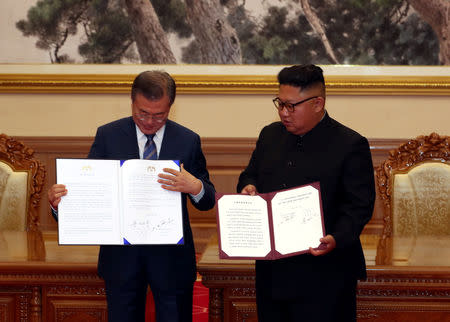 South Korean President Moon Jae-in and North Korean leader Kim Jong Un pose for photographs with the joint statement in Pyongyang, North Korea, September 19, 2018. Pyeongyang Press Corps/Pool via REUTERS